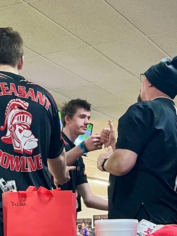 Pleasant's Tucker Ludwig fist bumps his father and bowling coach Bill Ludwig during the Division II boys bowling state tournament at HP Lanes  in Columbus Feb. 27, 2026.