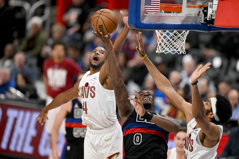 Detroit Pistons center Jalen Duren (0) drives to the basket between Cleveland Cavaliers forward Evan Mobley (4) and center Jarrett Allen on Feb. 27, 2026, in Detroit, Michigan.