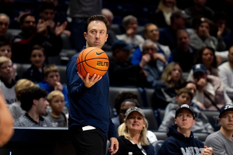 Xavier Musketeers head coach Richard Pitino holds the ball for the referee in the second half of the NCAA basketball game at the Cintas Center in Cincinnati.