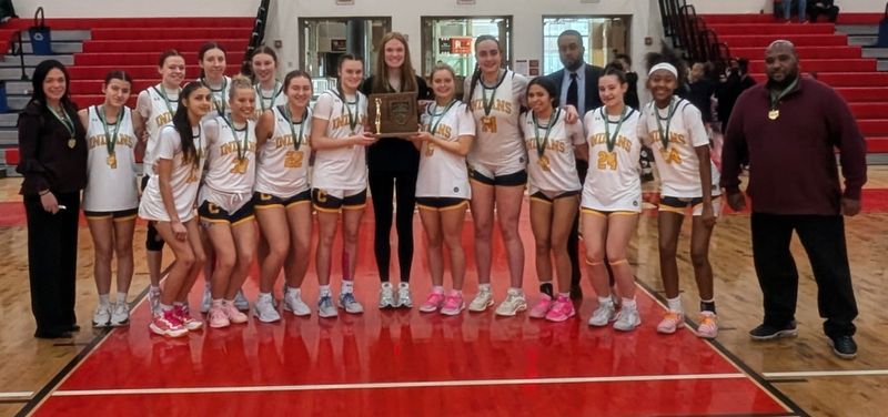The Copley girls basketball team poses with its Division III, Northeast 2 District title trophy on Feb. 28 after beating Ellet.