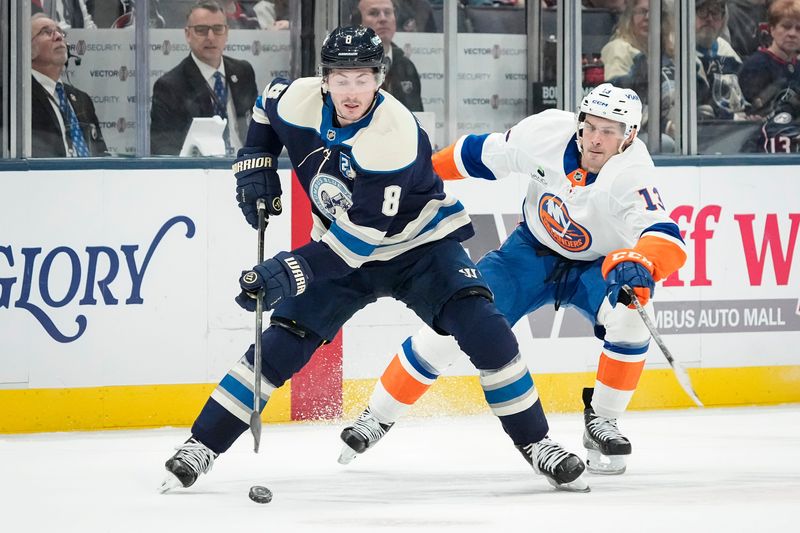 Blue Jackets defenseman Zach Werenski skates by Islanders center Mathew Barzal on Feb. 28.