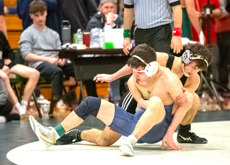 Genoa's Tyler Abbey controls Woodmore's D.J. Orcelletto in the 150 pound consolation match.