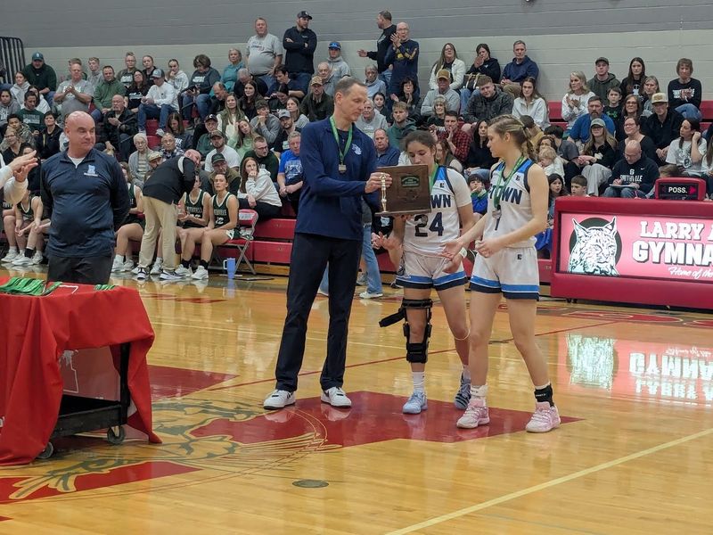 Rootstown coach Joe Leonard and seniors Cloe Bengtson and Colbie Curall accept their district runner-up trophy.