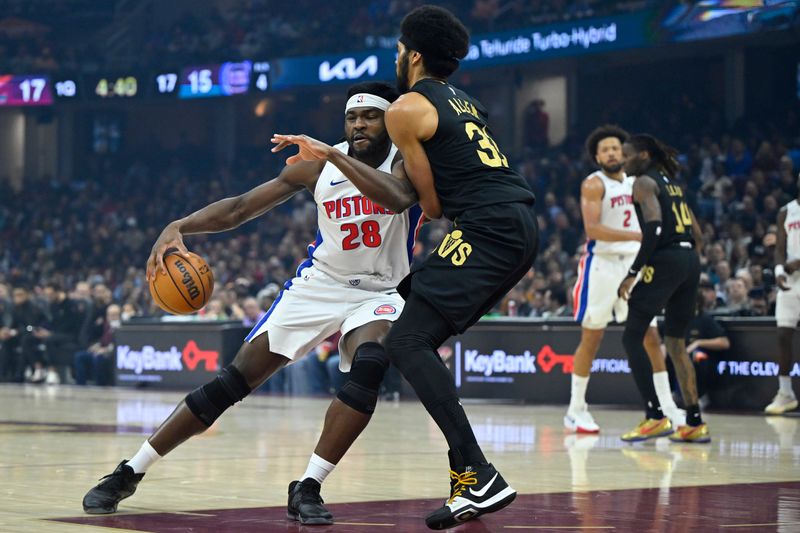 Mar 3, 2026; Cleveland, Ohio, USA; Detroit Pistons forward Isaiah Stewart (28) dribbles beside Cleveland Cavaliers center Jarrett Allen (31) in the first quarter at Rocket Arena. Mandatory Credit: David Richard-Imagn Images