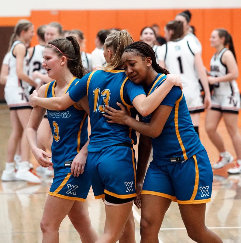 West Muskingum's Debra Allen, left, Lyla Johnson and Teriauna Brandford embrace as Tuscarawas Valley celebrates a 54-42 win in a Division V regional semifinal at Claymont High School on March 4 in Uhrichsville, Ohio. Allen and Brandford were part of a senior class that won two district titles in four years.