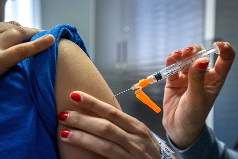 Medical Assistant Jasleen Kaur gives a vaccine to a patient Monday, Feb. 3, 2025 at the Indiana Immunization Coalition clinic. This patient received MMR, tetanus, polio and hepatitis B vaccines.