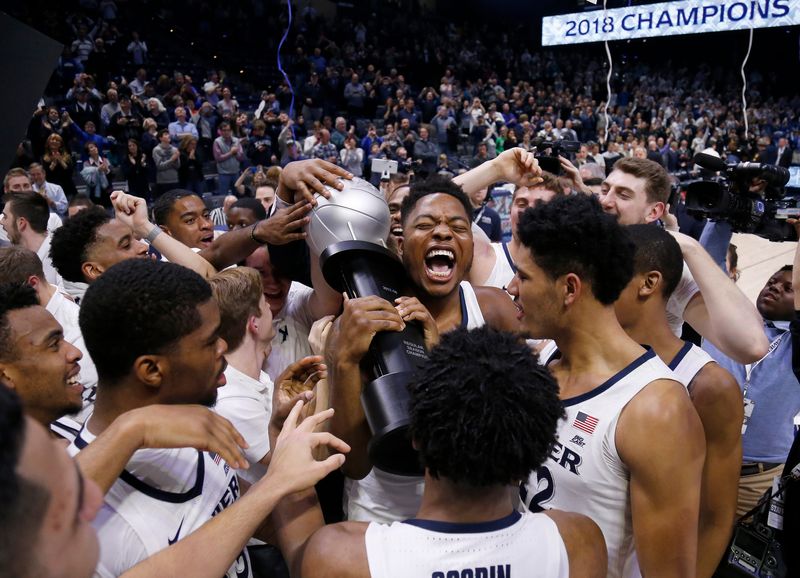 The Xavier Musketeers celebrate with the Big East regular season championship trophy after the NCAA Big East game between the Xavier Musketeers and the Providence Friars at the Cintas Center in Cincinnati in 2018.