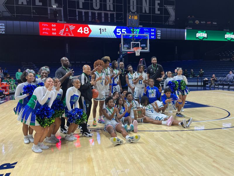 Winton Woods boys basketball team and cheerleaders pose with the district championship trophy March 6, 2026 at Cintas Center.