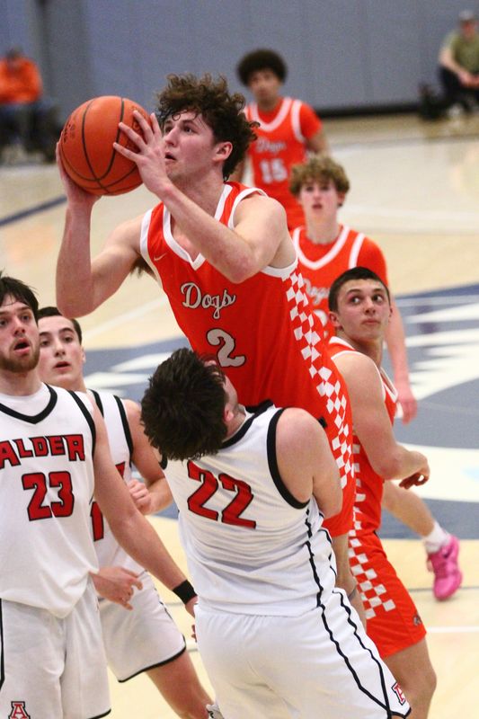 Heath's Jordan Kaminsky attempts to score over Jonathan Alder's Garrett Bauer during the Bulldogs' 46-29 loss in a Division IV district final at Mount Vernon Nazarene on March 6, 2026.