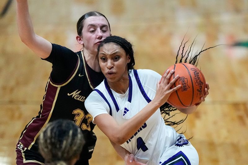 Pickerington Central's Zoe Coleman drives against New Albany's Hartley Rhoads (33) during a Division I regional final March 6 at Taft Coliseum.