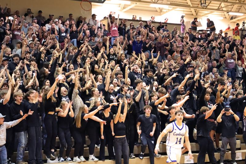 John Glenn fans get excited during the second half of the boys basketball team's Division IV district final game against neighboring Cambridge on March 6 at Muskingum University's Anne C. Steele Center. The Muskies won, 66-45, to advance to the regional semifinals against Maysville.