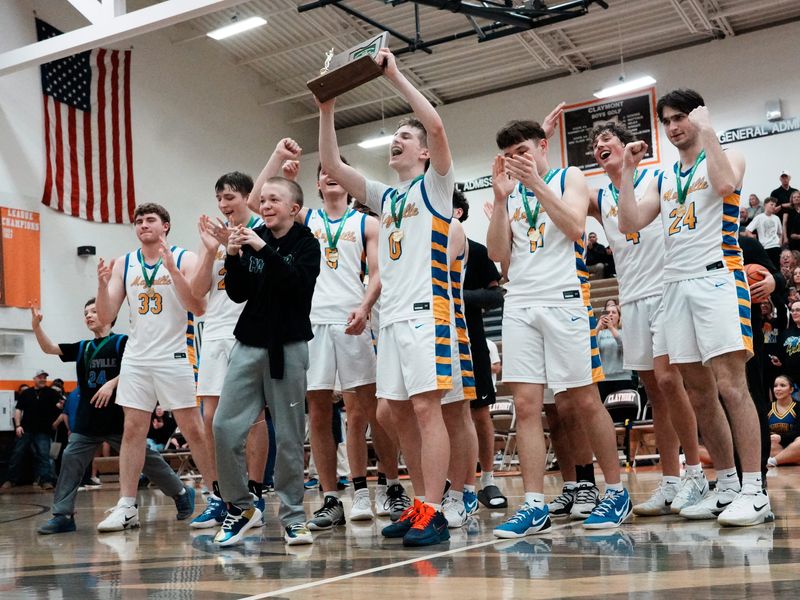 Gator Nichols hoists the championship trophy following Maysville's 72-44 win against Carrollton in a Division IV East District final on Friday, March 6, 2026, at Claymont High School in Uhrichsville, Ohio. Nichols scored game-high 37 points as Maysville reached its fourth straight regional.