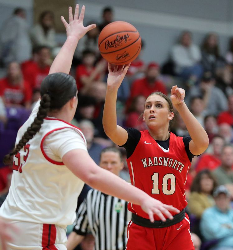 Wadsworth wing Lauren Decker (10) shoots over Mentor forward Ashlyn McKinney (53) during the first half of a Division I girls regional final basketball game at Barberton High School, March 7, 2026, in Barberton, Ohio.