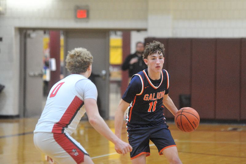 Galion's Cameron Smith looks to drive past Van Wert's Kalven Welch. Van Wert beat Galion 53-35 in a Division IV district championship at Paulding High School on March 7, 2026.