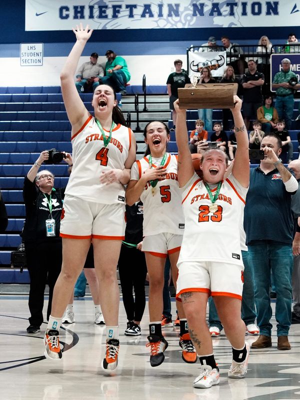 Strasburg seniors Ally Miller, left, Sofia Secrest and Olivia Spidell celebrate with the championship trophy following a 50-33 win agaisnt Reedsville Eastern in a Division VII regional final win on Saturday, March 7, 2026, at Jim Myers Gymnasium in Logan, Ohio. Strasburg allowed only 17 points in the final three quarters to reach its first state tournament in school history.