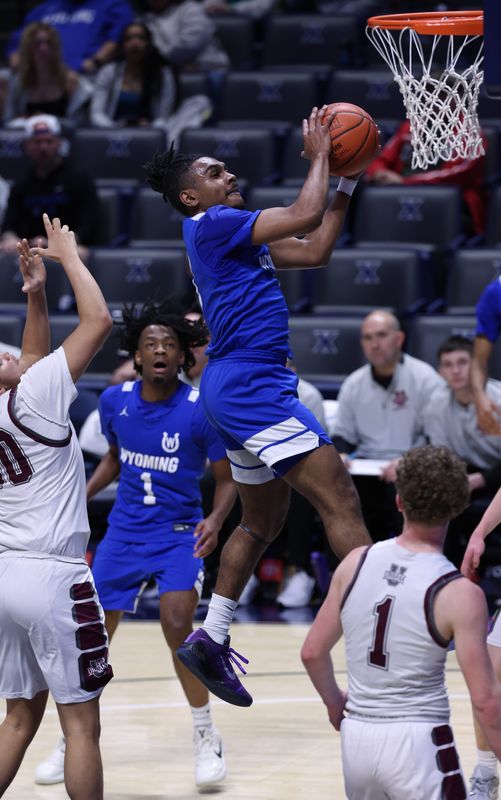 Darren Gray, a Wyoming senior, collects a rebound then lays it in for two second quarter points. Wyoming played Urbana in a Division IV district final, advancing in the tournament with a 59-31 victory at Cintas Center.