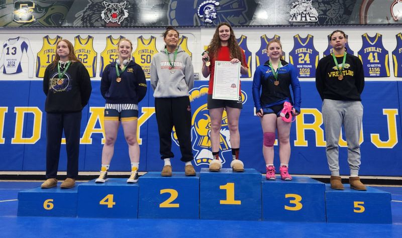 Crestview's Naomi Gearheart stands atop the podium as district champion of the 145-pound weight class. Findlay High School hosted the Northwest District wrestling meet for the girls on March 7, 2026.