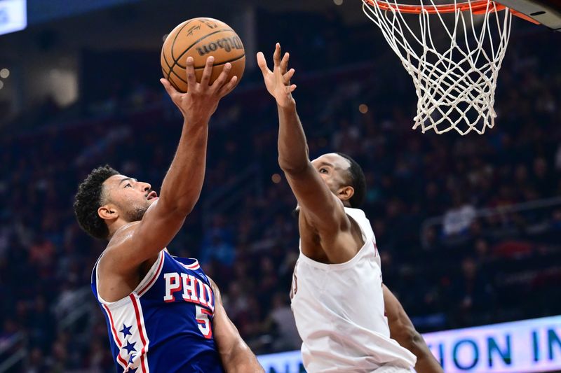Mar 9, 2026; Cleveland, Ohio, USA; Philadelphia 76ers guard Quentin Grimes (5) drives to the basket against Cleveland Cavaliers center Evan Mobley (4) during the first half at Rocket Arena. Mandatory Credit: Ken Blaze-Imagn Images