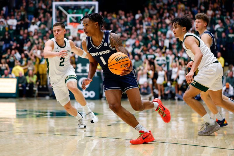 Utah State guard Elijah Perryman (1) controls the ball in the first half against Colorado State during their game at Moby Arena.Jan. 23.