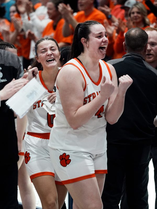 Strasburg senior Ally Miller and Addyson Sibila, left, celebrates on the sidelines following a 50-33 win against Reedsville Eastern in a Division VII regional final on Saturday, March 7, 2026, at Jim Myers Gymnasium in Logan, Ohio.