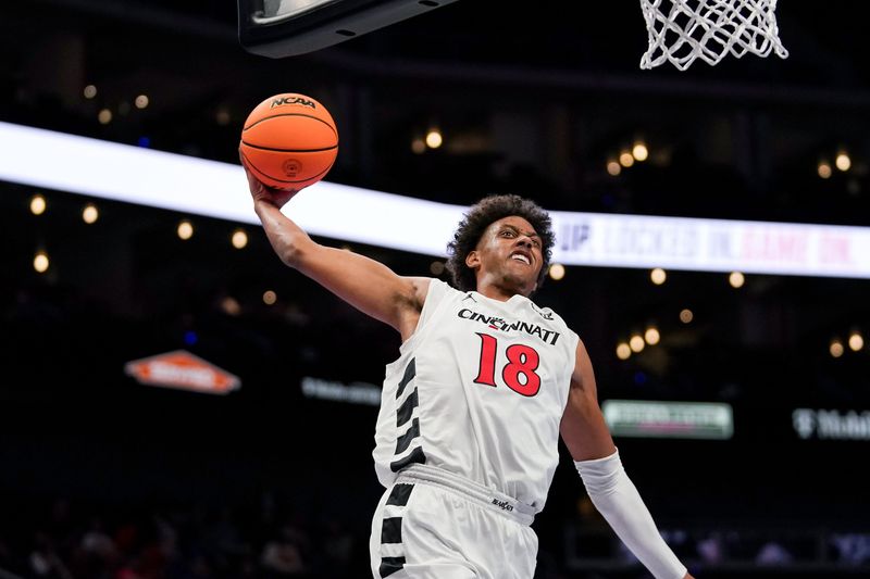 Cincinnati Bearcats forward Baba Miller (18) dunks the ball against Utah March 10 in the Big 12 tournament. The win put UC in the next round vs. UCF March 11.