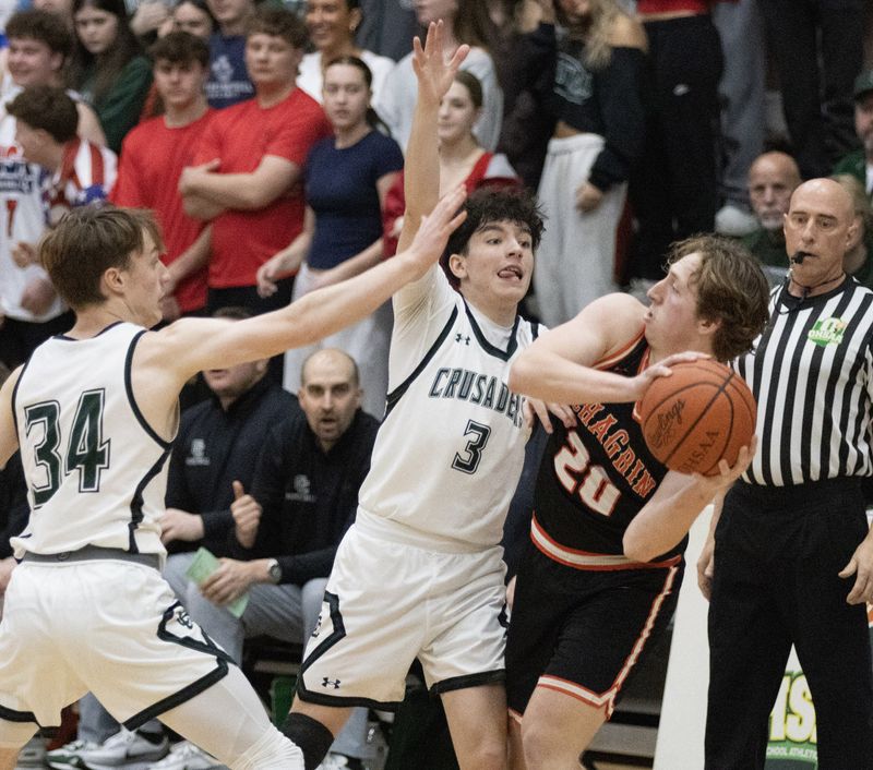 Central’s Lance Viacovsky (34) and Jake Bowling (3) pressures Chargin Falls’ Brady DeVito during a Division V regional semifinal Wednesday, March 11, 2026. Bob Rossiter / Special To The Canton Repository