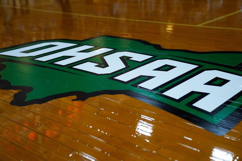 OHSAA logo on the court in the first half of the OHSAA state semifinal game at Vandalia Butler on Friday, March 13, 2026 in Vandalia, Ohio.