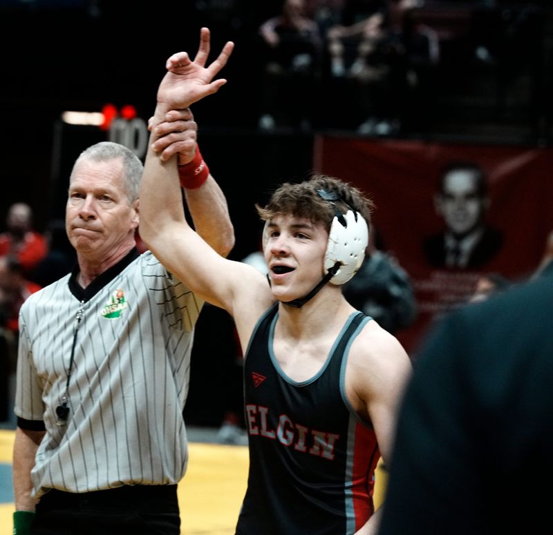 A referee raises the victorious hand of Marion Elgin's Cooper Schlaegel during a first-round match at 132 pounds in the Division IIl state wrestling tournament on Friday, March 13, 2026, at Ohio State's Value City Arena in Columbus. Schlaegel won by pin in 1:33.