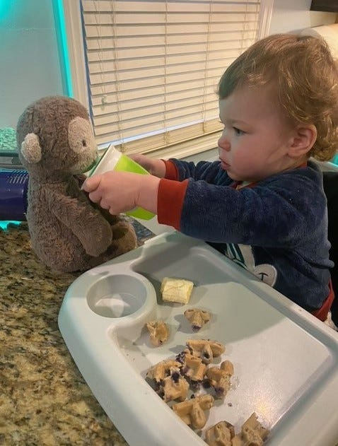 Arty Woodyard shares his sippy cup with Monkey.