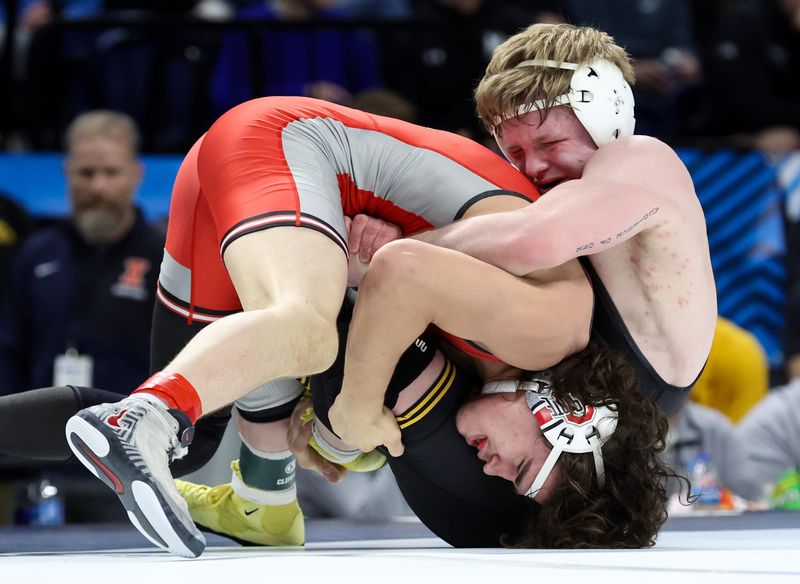 Mar 7, 2026; University Park, PA, USA; IowaÕs Victor Voinovich (right) grabs the upper torso of Ohio StateÕs Brandon Cannon (left) while wrestling in a 157-pound bout during the first round of the Big Ten Wrestling Championships at Bryce Jordan Center. Mandatory Credit: Matthew O'Haren-Imagn Images