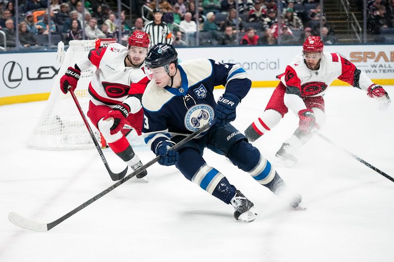 Columbus Blue Jackets center Charlie Coyle (3) skates around Carolina Hurricanes center Sebastian Aho (20) during the third period of the NHL hockey game at Nationwide Arena in Columbus on March 17, 2026.