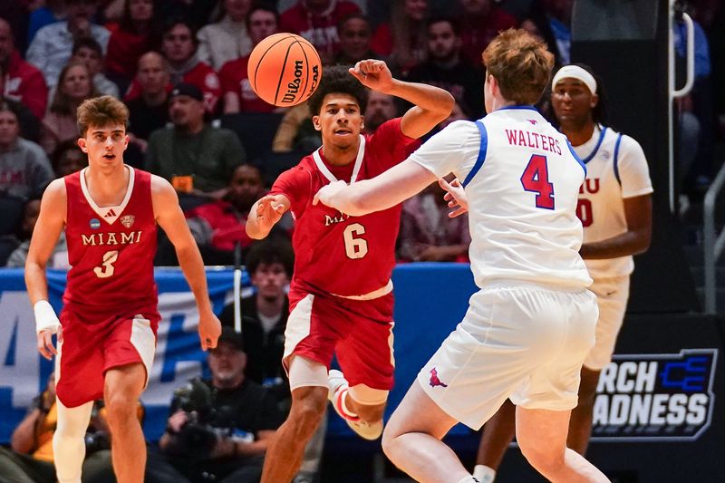 Miami (OH) RedHawks guard Justin Kirby (6) and Southern Methodist University Mustangs forward Sam Walters (4) reach for a loose ball in the first half of the NCAA Tournament First Four game between the Miami Redhawks and Southern Methodist University Mustangs, Wednesday, March 18, 2026, at University of Dayton Arena in Dayton, Oh.