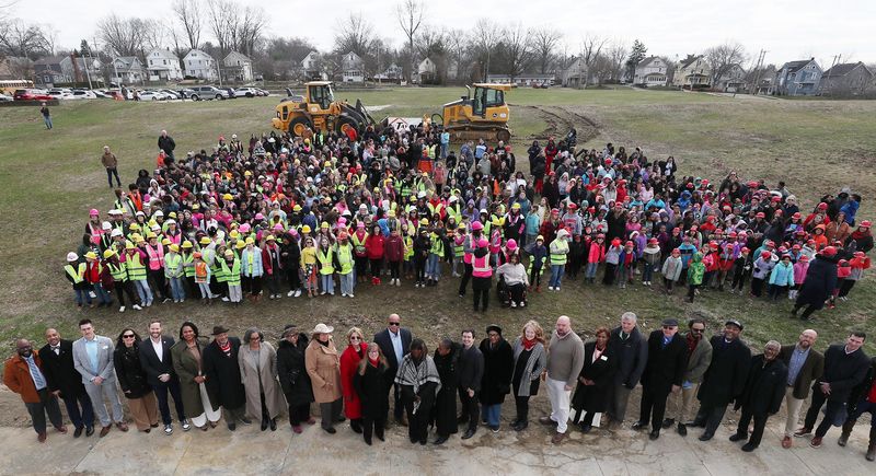 Students from Pfeiffer Elementary and Miller South School for the Visual and Performing Arts join officials for a group photo before the groundbreaking ceremony for the new building that will house both schools on the former Kenmore High School site in Akron on March 19, 2026.
