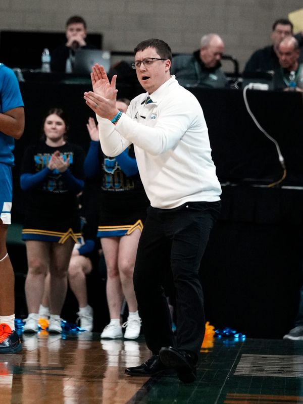 Head coach Dave Brown encourages his players from the bench during Maysville's 68-51 loss to Cincinnati Wyoming in a Division IV state semifinal on Thursday, March 18, 2026, at Wright State's Nutter Center. Wyoming advanced to its first state final in program history.