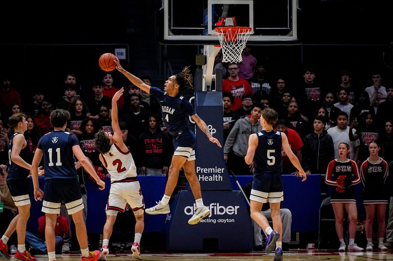 Hoban’s John Johnson (4) rejects the shot attempt by Steubenville High School’s Santino Haney (2) during an OHSAA DIII boys basketball state semifinal game, March 19, 2026, at University of Dayton Arena in Dayton, Ohio.