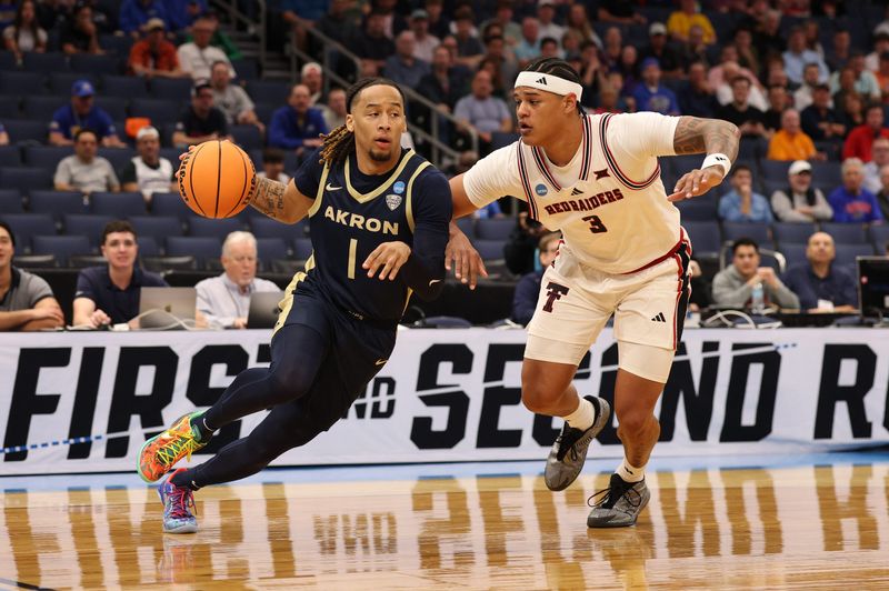 Mar 20, 2026; Tampa, FL, USA; Akron Zips guard Shammah Scott (1) drives against Texas Tech Red Raiders forward Lejuan Watts (3) in the first half during a first round game of the men's 2026 NCAA Tournament at Benchmark International Arena. Mandatory Credit: Nathan Ray Seebeck-Imagn Images