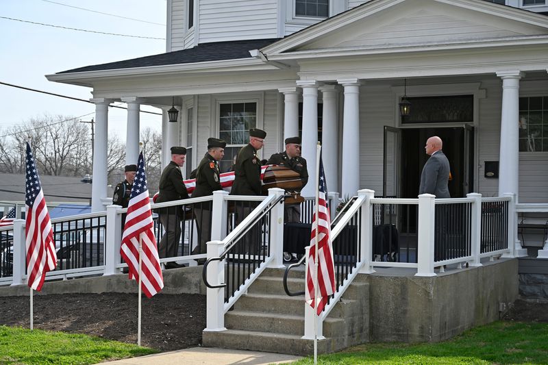 A military Honor Guard escort the remains of Staff Sgt Benjamin Pennington into the Trowbridge Funeral Home as he returned home following his death in the war in Iran Friday, March 20, 2026 in Elizabethtown Ky