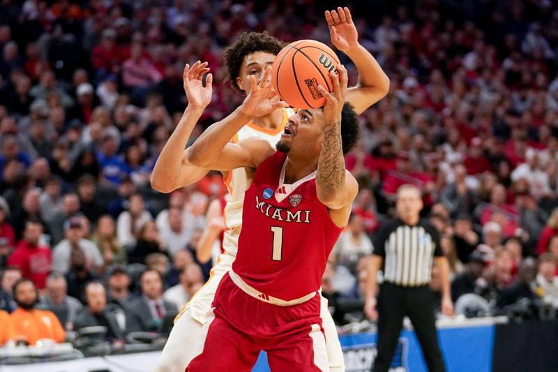 Miami guard Trey Perry puts up a shot while being pressured by Tennessee's Nate Ament during the Volunteers' 78-56 victory in the first round of the NCAA Tournament.