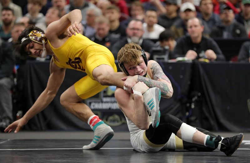 Purdue’s Joey Blaze, right, goes after Arizona State’s Nicco Ruiz during their 165 pound match in the NCAA Division I wrestling championships at Rocket Arena, March 21, 2026, in Cleveland, Ohio.