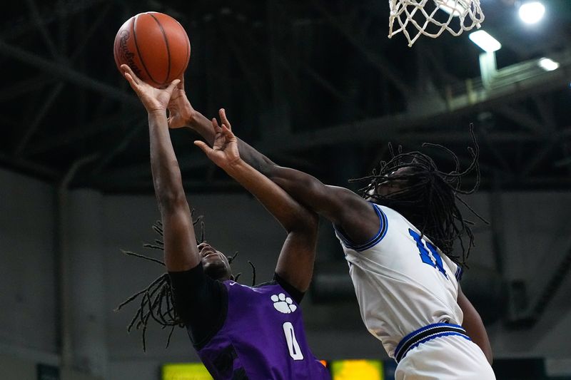 Hilliard Bradley's Jayden Reed-Davis (11) blocks a shot from Pickerington Central's KD Smith (0) during the second half of their Division I state semifinal. Reed-Davis later made the winning basket with less than a second to play.