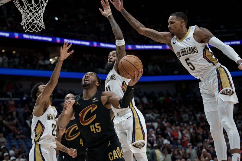 Cleveland Cavaliers guard Donovan Mitchell (45) shoots as New Orleans Pelicans forward Trey Murphy III (25), guard Saddiq Bey (41) and guard Dejounte Murray (5) defend March 21, 2026, in New Orleans, Louisiana.