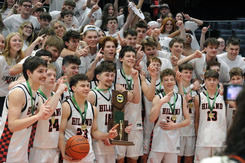 Hiland's basketball team takes a photo with loyal supporters after the game. The Hawks won the Division VI state championship game in double overtime over Marion Local.