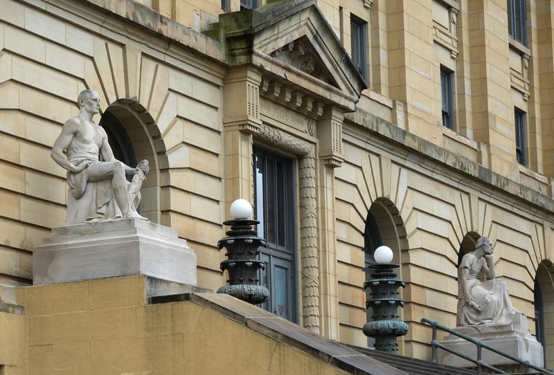 Statues representing Justice and Law, created by Cleveland sculptor Herman Matzen, are viewed on the High Street side of the Summit County Courthouse in Akron on March 23, 2026.