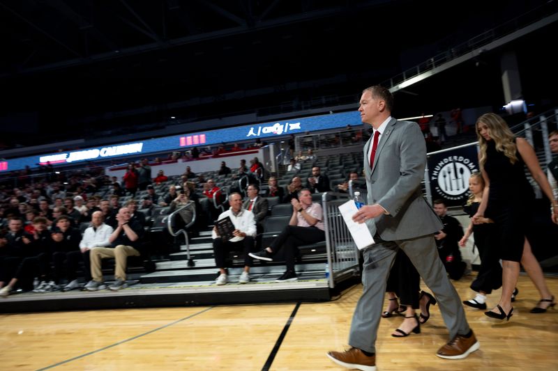 Cincinnati head coach Jerrod Calhoun walks into the arena to cheers during a press conference announcing him as the head men's basketball coach at Fifth Third Arena in Cincinnati on Wednesday, March 25, 2026.