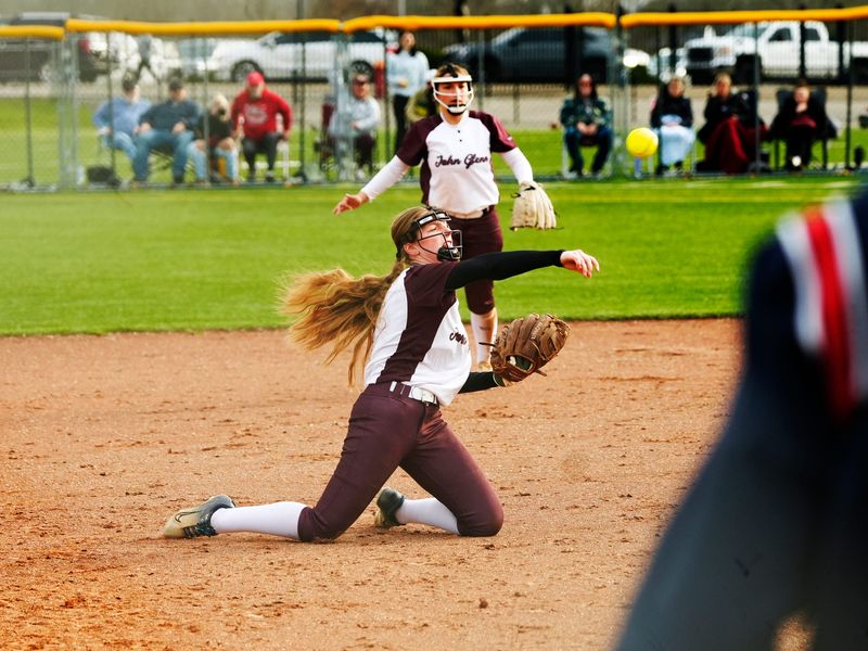 John Glenn third baseman Ava Miller throws out to first base after making a diving stab against visiting Indian Valley during a high school softball game on Wednesday, March 25, 2026, in New Concord, Ohio. John Glenn won, 7-1, to improve to 2-0.