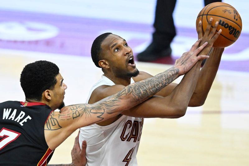 Mar 25, 2026; Cleveland, Ohio, USA; Miami Heat center Kel'el Ware (7) defends a shot by Cleveland Cavaliers center Evan Mobley (4) in the fourth quarter at Rocket Arena. Mandatory Credit: David Richard-Imagn Images