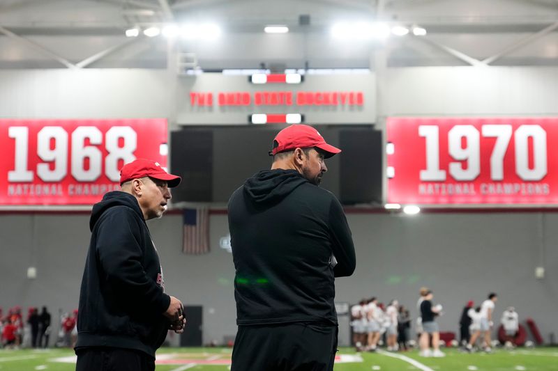 Ohio State Buckeyes head coach Ryan Day talks to assistant athletic director for football sports performance Mickey Marotti during the first day of spring workouts for the 2026 football season at Woody Hayes Athletic Complex in Columbus on March 10, 2026.