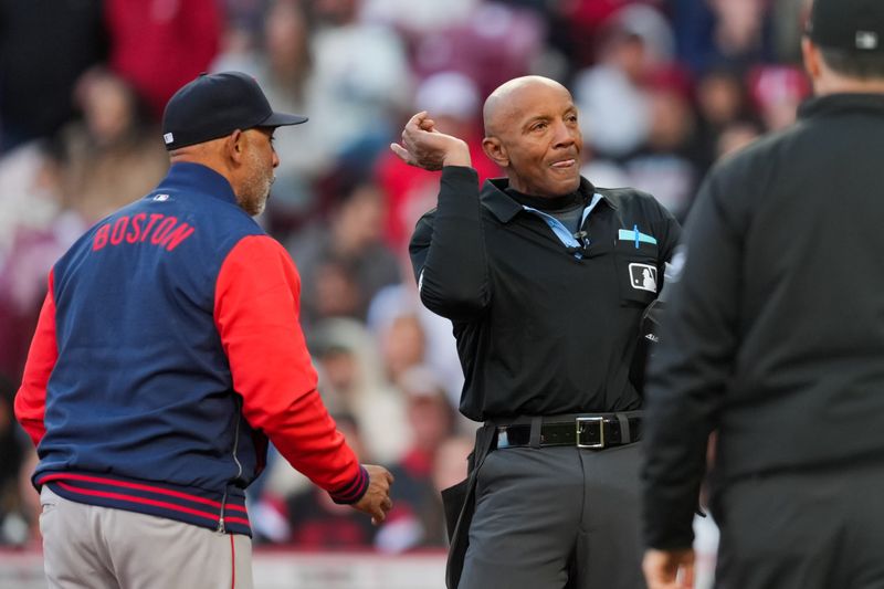Mar 28, 2026; Cincinnati, Ohio, USA; MLB umpire CB Bucknor (54) ejects Boston Red Sox manager Alex Cora (13) during the game against the Cincinnati Reds in the eighth inning at Great American Ball Park. Mandatory Credit: Aaron Doster-Imagn Images
