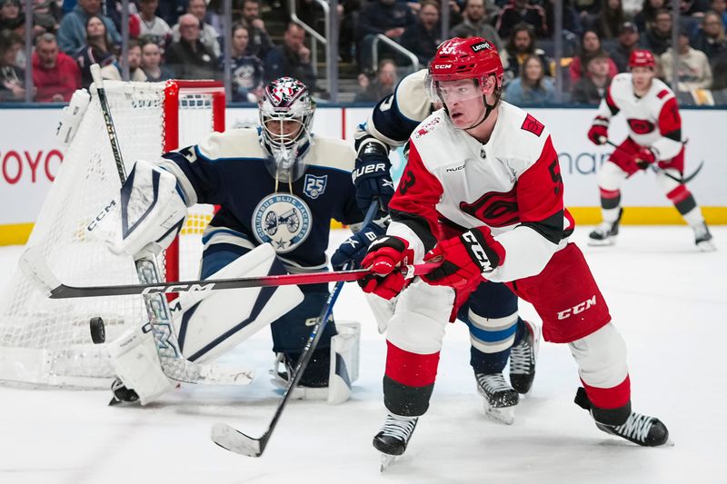 Hurricanes right wing Jackson Blake moves the puck in front of Blue Jackets goaltender Jet Greaves on March 31.