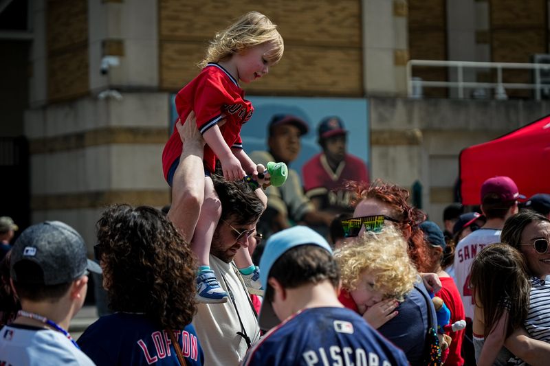 Fans mingle outside before the start of the home opener Cleveland Guardians game against the Chicago White Sox on April 3 at Progressive Field in Cleveland.
